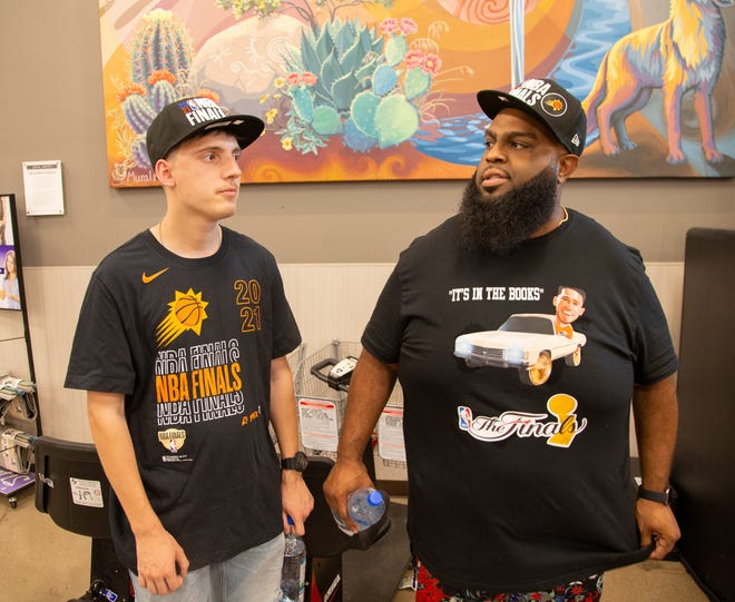 Gavin Powers and Chaun Brown wear T-shirts to support the Suns before Game 2 of the NBA Finals at Fry's Food and Drug in Phoenix on July 8, 2021.