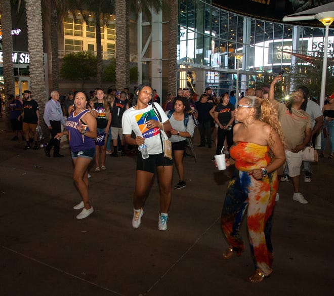 Fans dance to celebrate after the Suns beat the Milwaukee Bucks 118-108 in Game 2 of the NBA Finals outside the Phoenix Suns Arena in Phoenix on July 8, 2021.