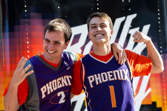 Alex and James Huesing smile at the Phoenix Suns Arena for Game 2 of the NBA finals vs. the Milwaukee Bucks on July 8, 2021.