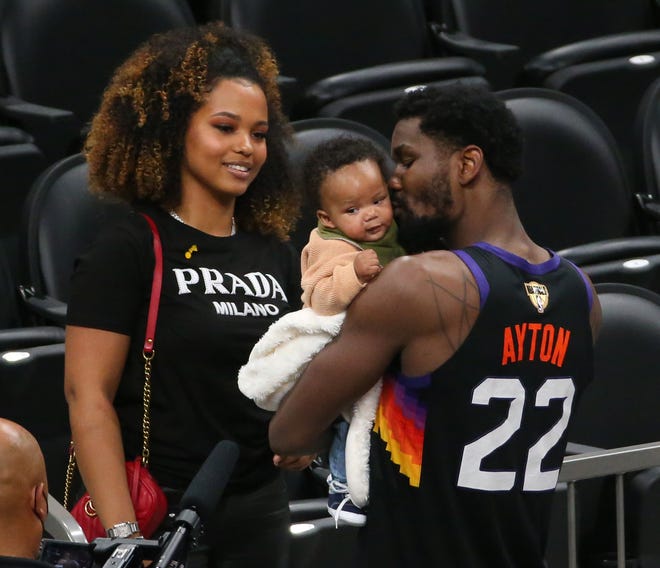 Phoenix Suns center Deandre Ayton kisses his son, Deandre Jr., with his girlfriend Anissa Evans watching after beating the Milwaukee Bucks 118-108 in Game 2 of the NBA Finals at Phoenix Suns Arena July 8, 2021.