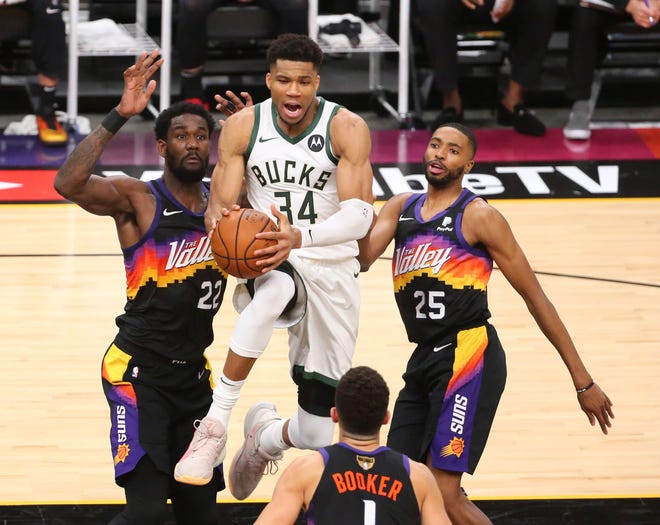 Milwaukee Bucks forward Giannis Antetokounmpo (34) looks to pass against the Phoenix Suns during Game 2 of the NBA Finals at Phoenix Suns Arena July 8, 2021.