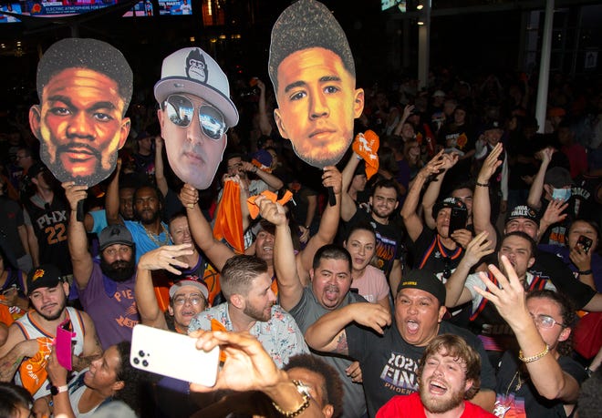 Suns fans celebrate after their team beat the Milwaukee Bucks 118-108 in Game 2 of the NBA Finals outside the Phoenix Suns Arena in Phoenix on July 8, 2021.