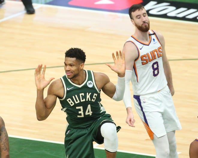 Milwaukee Bucks forward Giannis Antetokounmpo (34) reacts after slamming tow against Phoenix Suns forward Frank Kaminsky (8) during Game 3 of the NBA Finals at Fiserv Forum July 11, 2021.