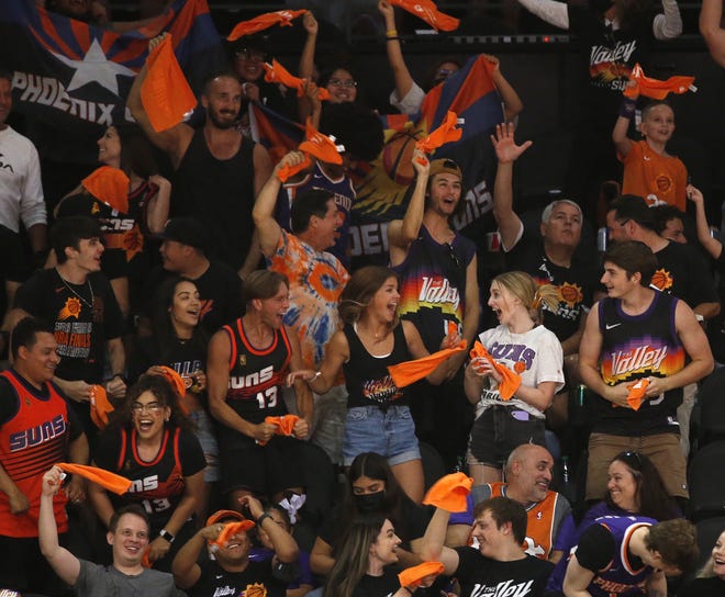 Fans react to a basket as the Phoenix Suns take on the Milwaukee Bucks during a Road Rally watch party of Game 3 of the NBA Finals at the Phoenix Suns Arena in downtown Phoenix on July 11, 2021.