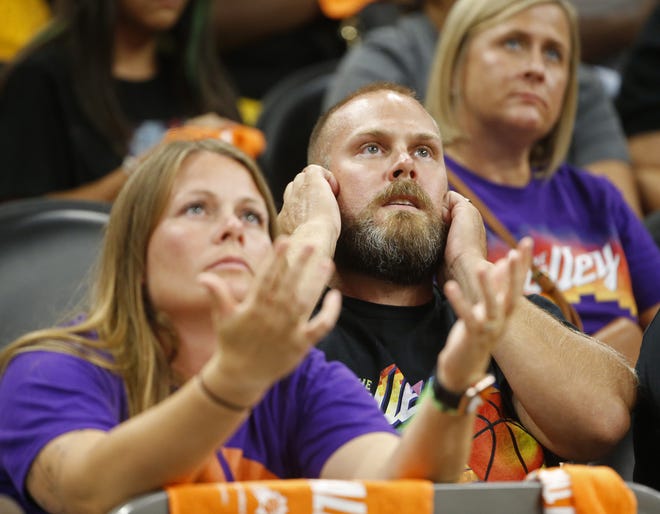 Suns fans react to the Bucks taking a significant lead in the fourth quarter as they watch on the jumbotron at the Phoenix Suns Arena on July 11, 2021.