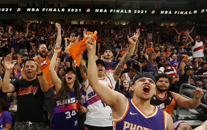 Fans watch the Phoenix Suns take on the Milwaukee Bucks during a Road Rally watch party of Game 3 of the NBA Finals at the Phoenix Suns Arena in downtown Phoenix on July 11, 2021.