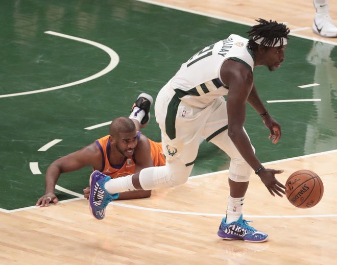 Phoenix Suns guard Chris Paul (3) turns the ball over to Milwaukee Bucks guard Jrue Holiday (21) in the final seconds of Game 4 of the NBA Finals at Fiserv Forum July 14, 2021.