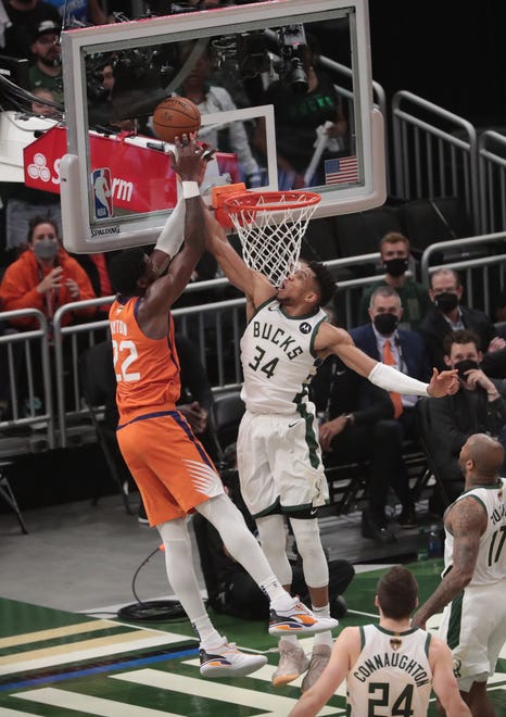 Phoenix Suns center Deandre Ayton (22) has his shot blocked by Milwaukee Bucks forward Giannis Antetokounmpo (34) during Game 4 of the NBA Finals at Fiserv Forum July 14, 2021.