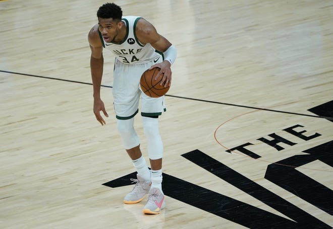Milwaukee Bucks forward Giannis Antetokounmpo (34) bring the ball up during the third quarter of Game 5 of the NBA Finals at Footprint Center in Phoenix on Saturday.