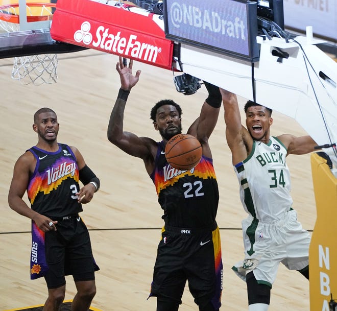 Milwaukee Bucks forward Giannis Antetokounmpo (34) is fouled by Phoenix Suns center Deandre Ayton (22) during the third quarter of Game 5 of the NBA Finals at Footprint Center in Phoenix on Saturday.