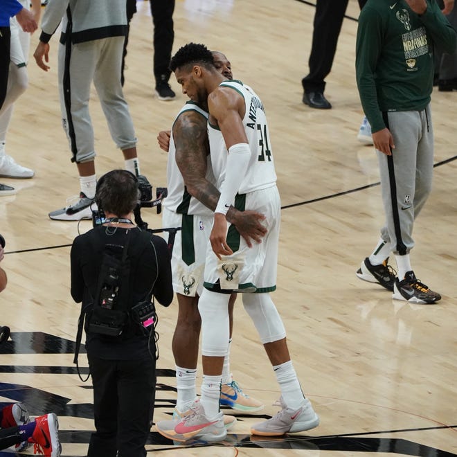 Milwaukee Bucks forward Giannis Antetokounmpo (34) and Milwaukee Bucks forward P.J. Tucker (17) celebrate the win after Game 5 of of the Bucks 123-119 win over the Phoenix Suns in the NBA Finals at Footprint Center in Phoenix on Saturday.