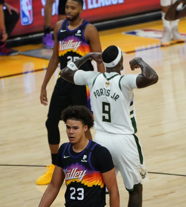 Milwaukee Bucks center Bobby Portis (9) flexes after getting fouled during the second quarter of Game 5 of the NBA Finals at Footprint Center in Phoenix on Saturday.