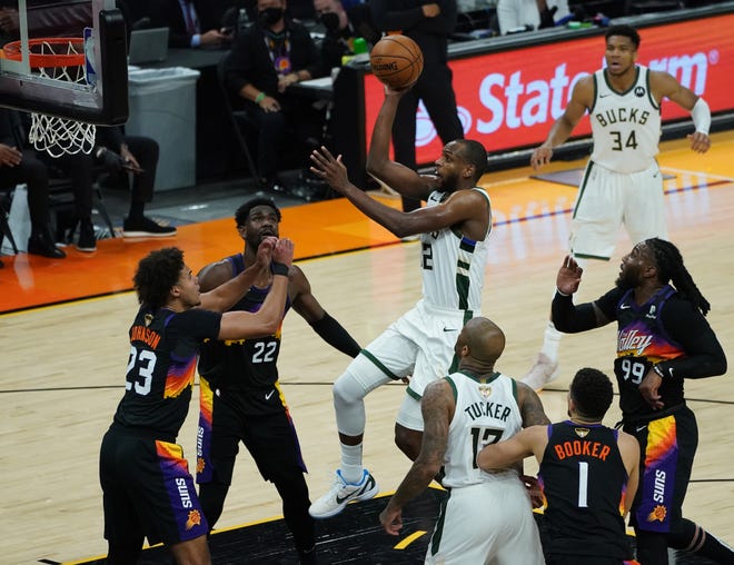 Milwaukee Bucks forward Khris Middleton (22) shoots during the second quarter of Game 5 of the NBA Finals at Footprint Center in Phoenix on Saturday.