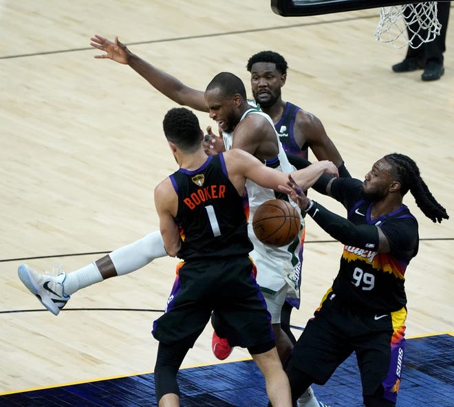 Milwaukee Bucks forward Khris Middleton (22) is fouled as the ball goes out of bounds during the fourth quarter of Game 5 of Bucks 123-119 win over the Phoenix Suns in the NBA Finals at Footprint Center in Phoenix on Saturday.