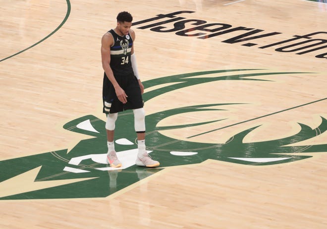Milwaukee Bucks forward Giannis Antetokounmpo (34) walks back on defense against the Phoenix Suns during Game 6 of the NBA Finals at Fiserv Forum July 20, 2021.