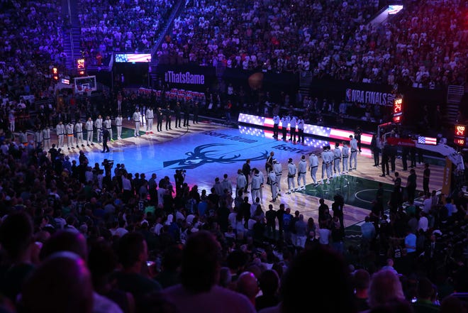 Phoenix Suns and Milwaukee Bucks players stand for the national anthem before Game 6 of the NBA Finals at Fiserv Forum July 20, 2021.