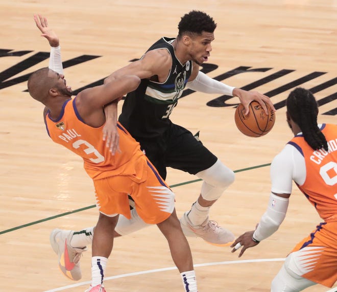Phoenix Suns guard Chris Paul (3) defends against Milwaukee Bucks forward Giannis Antetokounmpo (34) during Game 6 of the NBA Finals at Fiserv Forum July 20, 2021.