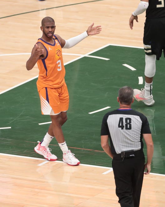 Phoenix Suns guard Chris Paul (3) questions a call by referee Scott Foster (48) during Game 6 of the NBA Finals against the Milwaukee Bucks at Fiserv Forum July 20, 2021.
