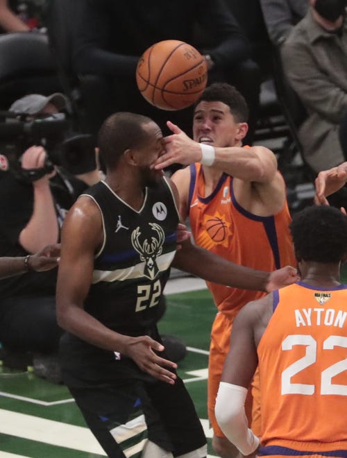 Phoenix Suns guard Devin Booker (1) loses the ball against Milwaukee Bucks forward Khris Middleton (22) during Game 6 of the NBA Finals at Fiserv Forum July 20, 2021.