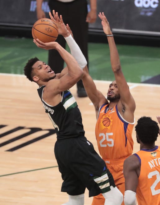 Milwaukee Bucks forward Giannis Antetokounmpo (34) is fouled by Phoenix Suns forward Mikal Bridges (25) during Game 6 of the NBA Finals at Fiserv Forum July 20, 2021.