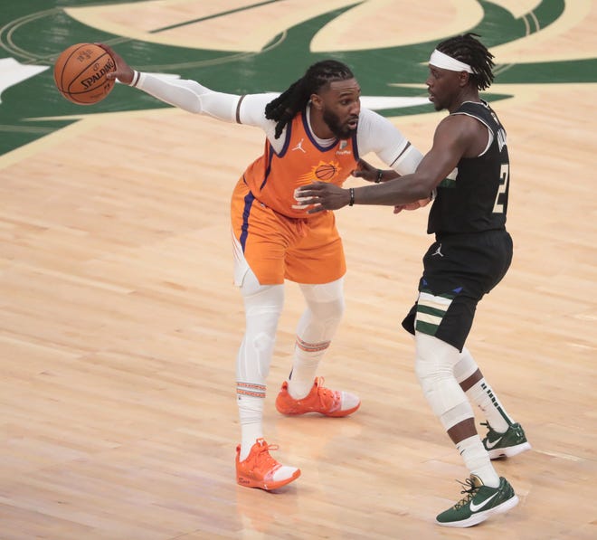 Phoenix Suns forward Jae Crowder (99) looks to pass against Milwaukee Bucks guard Jrue Holiday (21) during Game 6 of the NBA Finals at Fiserv Forum July 20, 2021.