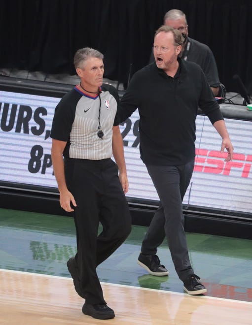 Milwaukee Bucks head coach Mike Budenholzer argues a call with referee Scott Foster (48) during Game 6 of the NBA Finals against the Phoenix Suns at Fiserv Forum July 20, 2021.