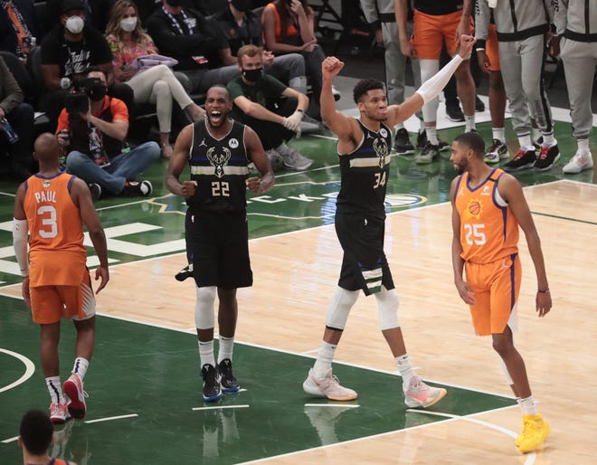 Milwaukee Bucks forwards Khris Middleton (22) and Giannis Antetokounmpo (34) celebrate after winning Game 6 of the NBA Finals against the Phoenix Suns at Fiserv Forum July 20, 2021.