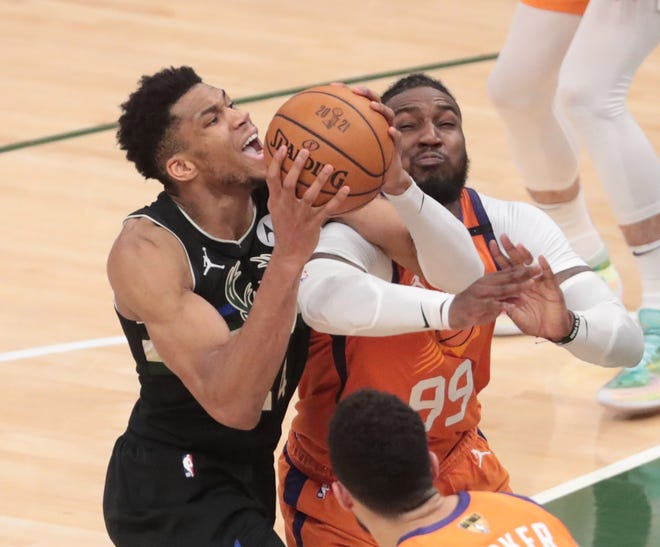 Milwaukee Bucks forward Giannis Antetokounmpo (34) is fouled by Phoenix Suns forward Jae Crowder (99) during Game 6 of the NBA Finals at Fiserv Forum July 20, 2021.