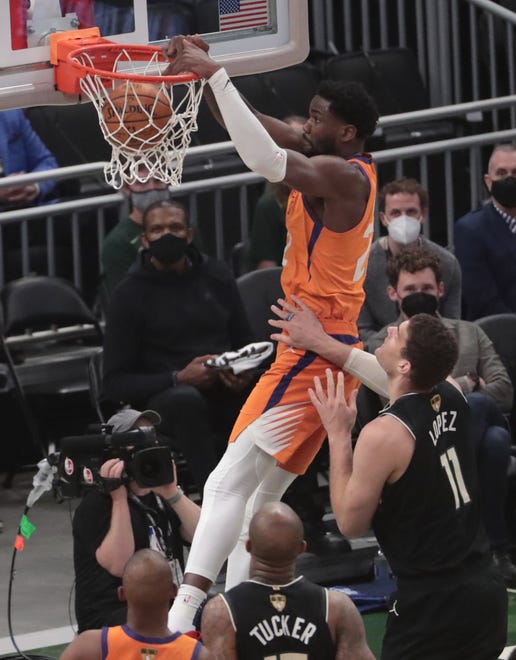 Phoenix Suns center Deandre Ayton (22) slams two against Milwaukee Bucks center Brook Lopez (11) during Game 6 of the NBA Finals at Fiserv Forum July 20, 2021.
