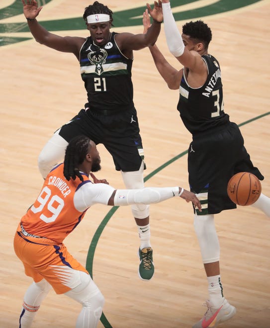 Phoenix Suns forward Jae Crowder (99) passes against Milwaukee Bucks guard Jrue Holiday (21) and forward Giannis Antetokounmpo (34) during Game 6 of the NBA Finals at Fiserv Forum July 20, 2021.