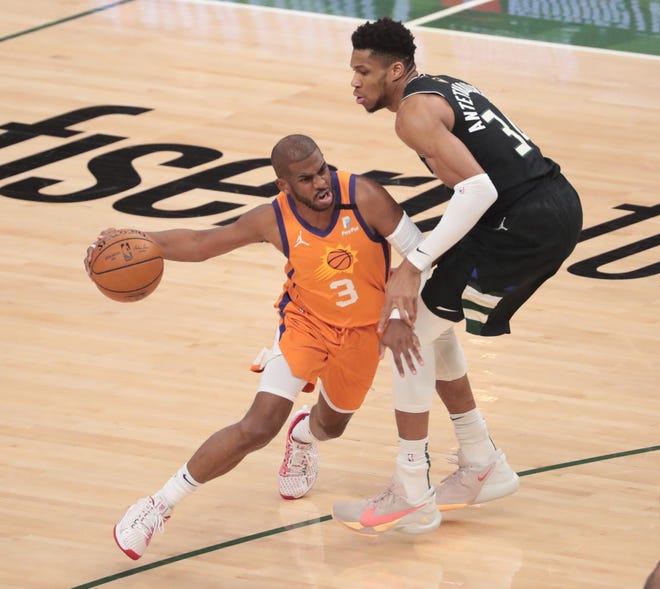 Phoenix Suns forward Cameron Johnson (23) is defended by Milwaukee Bucks forward Giannis Antetokounmpo (34) during Game 6 of the NBA Finals at Fiserv Forum July 20, 2021.