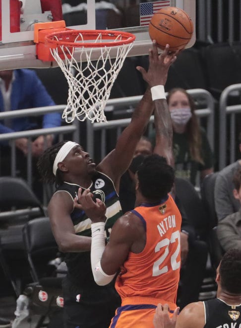 Phoenix Suns center Deandre Ayton (22) blocks a shot by Milwaukee Bucks guard Jrue Holiday (21) during Game 6 of the NBA Finals at Fiserv Forum July 20, 2021.
