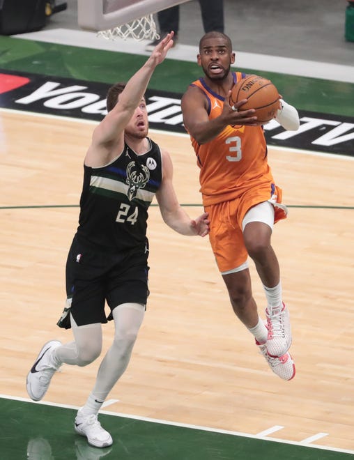 Phoenix Suns guard Chris Paul (3) puts a shot up against Milwaukee Bucks guard Pat Connaughton (24) during Game 6 of the NBA Finals at Fiserv Forum July 20, 2021.