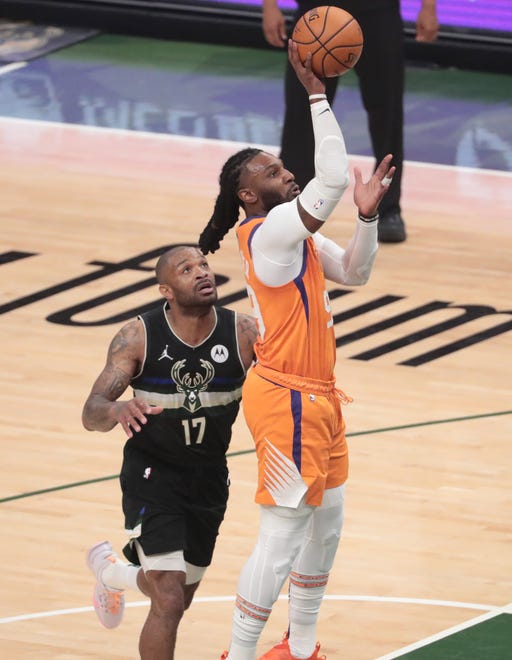 Phoenix Suns forward Jae Crowder (99) shoots in front of Milwaukee Bucks forward P.J. Tucker (17) during Game 6 of the NBA Finals at Fiserv Forum July 20, 2021.