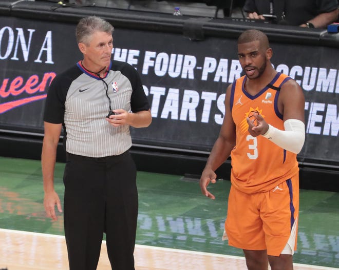 Phoenix Suns guard Chris Paul (3) questions a call by referee Scott Foster (48) during Game 6 of the NBA Finals against the Milwaukee Bucks at Fiserv Forum on July 20, 2021.