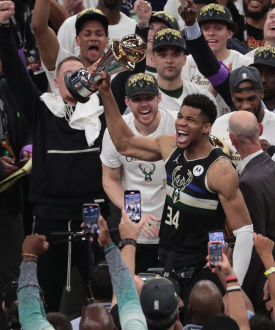 Milwaukee Bucks forward Giannis Antetokounmpo (34) holds the MVP trophy after beating the Phoenix Suns in Game 6 of the NBA Finals at Fiserv Forum July 20, 2021.