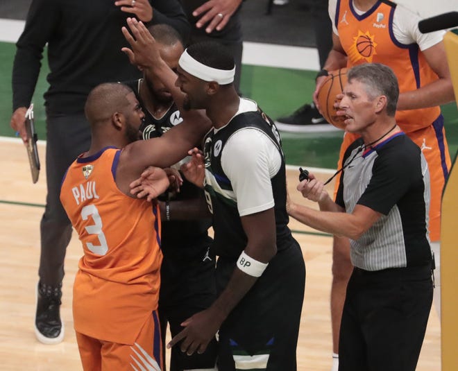 Phoenix Suns guard Chris Paul (3) tries to argue with referee Scott Foster (48) while Milwaukee Bucks center Bobby Portis (9) gets in the middle during Game 6 of the NBA Finals at Fiserv Forum on July 20, 2021.