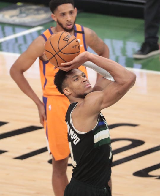 Milwaukee Bucks forward Giannis Antetokounmpo (34) shoots a free throw against the Phoenix Suns during Game 6 of the NBA Finals at Fiserv Forum July 20, 2021.