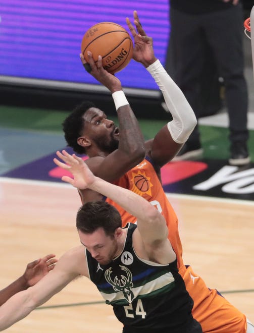 Phoenix Suns center Deandre Ayton (22) is fouled by Milwaukee Bucks guard Pat Connaughton (24) during Game 6 of the NBA Finals at Fiserv Forum July 20, 2021.