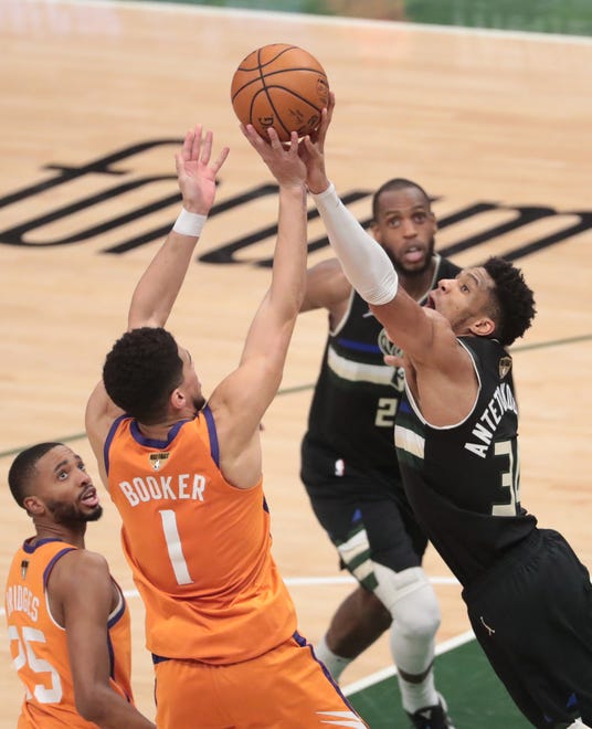 Phoenix Suns guard Devin Booker (1) has his shot blocked by Milwaukee Bucks forward Giannis Antetokounmpo (34) during Game 6 of the NBA Finals at Fiserv Forum July 20, 2021.