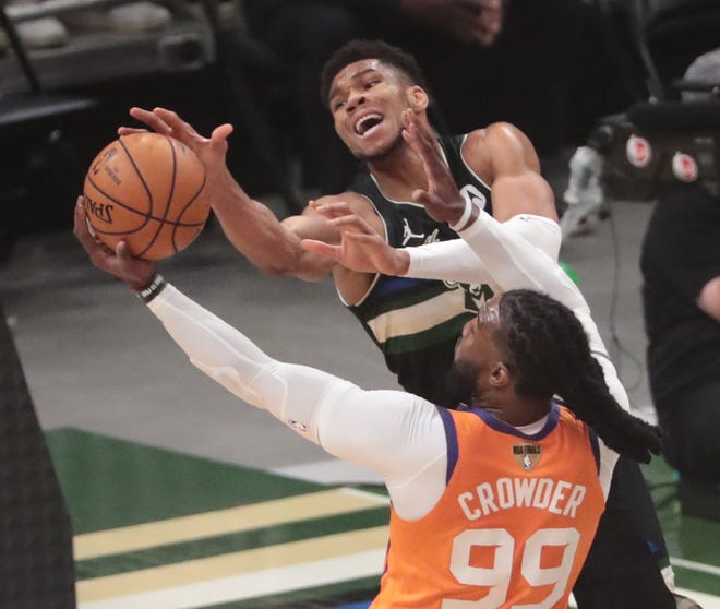 Milwaukee Bucks forward Giannis Antetokounmpo (34) is defended by Phoenix Suns forward Jae Crowder (99) during Game 6 of the NBA Finals at Fiserv Forum July 20, 2021.