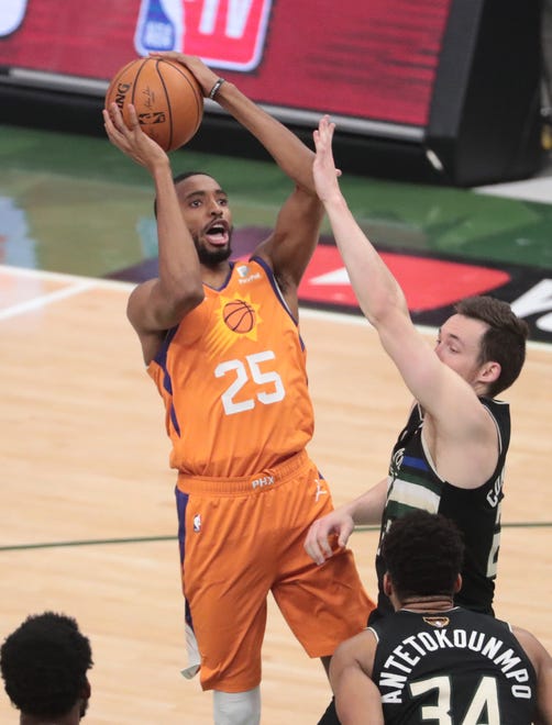 Phoenix Suns forward Mikal Bridges (25) shoots over Milwaukee Bucks guard Pat Connaughton (24) during Game 6 of the NBA Finals at Fiserv Forum July 20, 2021.