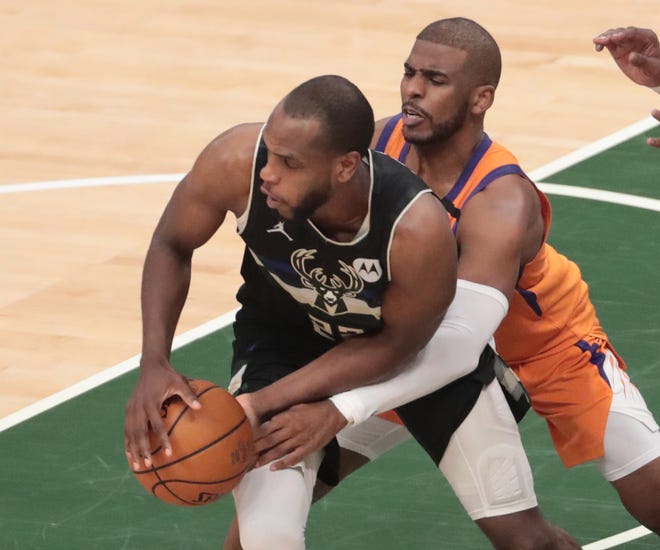 Phoenix Suns guard Chris Paul (3) defends against Milwaukee Bucks forward Khris Middleton (22) during Game 6 of the NBA Finals at Fiserv Forum July 20, 2021.