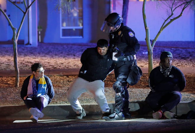 Police arrest protesters on 9th and Garfield streets in downtown Phoenix on May 31, 2020. People have been demonstrating for George Floyd, killed by police in Minnesota, and Dion Johnson, shot by an Arizona Department of Public Safety officer in Phoenix.