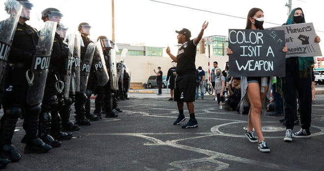 Protester Robert Dossie expresses his feeling to the Phoenix Police officers in response to George Floyd, who died in police custody on May 25, 2020, in Minneapolis, Phoenix, June 1, Arizona.