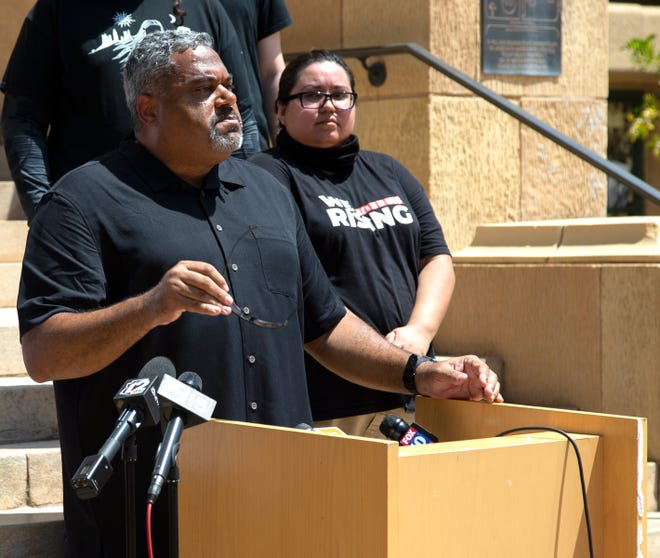 J.J. Westgate, president of the Black Phoenix Institute, takes off his sunglasses while speaking during a news conference at Cesar Chavez Plaza in downtown Phoenix on Aug. 6, 2021. The gathering was a response to the Department of Justice's investigation into the Phoenix Police Department.