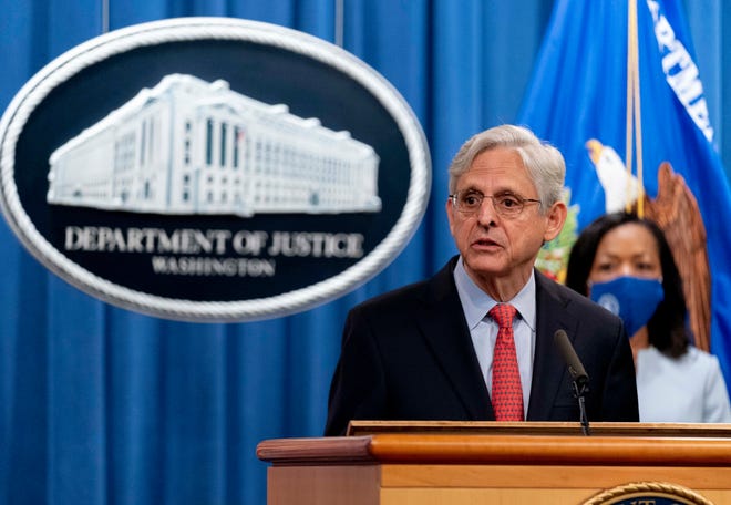 Attorney General Merrick Garland, accompanied by Assistant Attorney General for Civil Rights Kristen Clarke, right, speaks at a news conference at the Department of Justice in Washington, Thursday, Aug. 5, 2021, where he announced that the Department of Justice is opening an investigation into the city of Phoenix and the Phoenix Police Department.