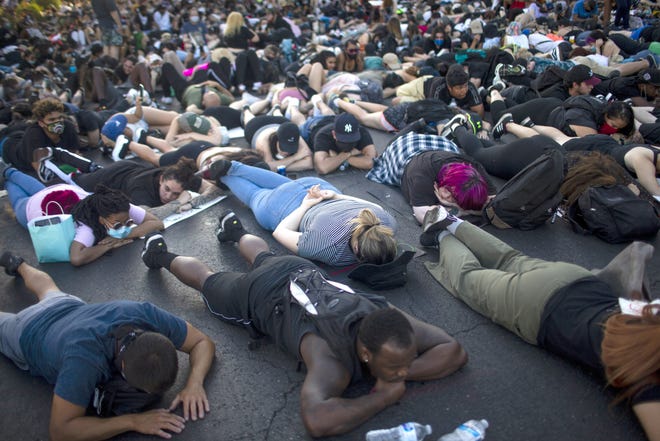 Hundreds of people lay down on Van Buren Street in downtown Phoenix for 8 minutes as part of the tenth day of protests on June 6, 2020, on behalf of George Floyd, Dion Johnson, and others who were killed by police across the country. The protest was held in solidarity with protests across the country against police violence.