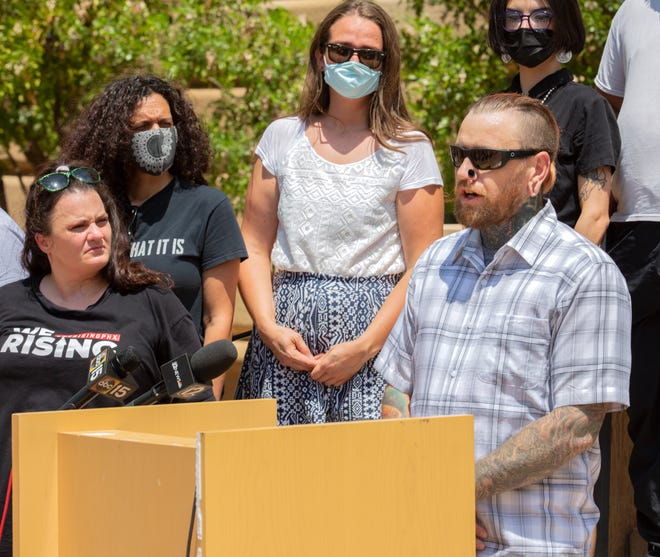 Robert Schafer, a member of the W.E. Rising Project, speaks during a protest at Cesar Chavez Plaza in downtown Phoenix on Aug. 6, 2021. The gathering was a response to the Department of Justice's investigation into the Phoenix Police Department.