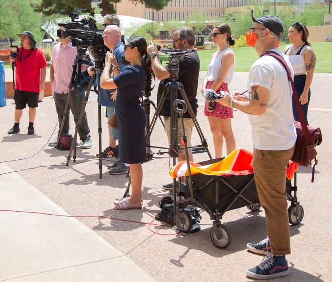 Spectators and media crews film a protest at Cesar Chavez Plaza in downtown Phoenix on Aug. 6, 2021. The gathering was a response to the Department of Justice's investigation into the Phoenix Police Department.